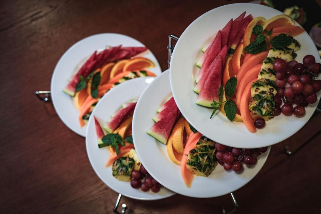 three plates of food with fruit on a table at Myrkdalen Resort Hotel in Myrkdalen