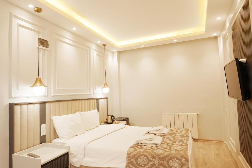 Postel nebo postele na pokoji v ubytování Ararat Hotel