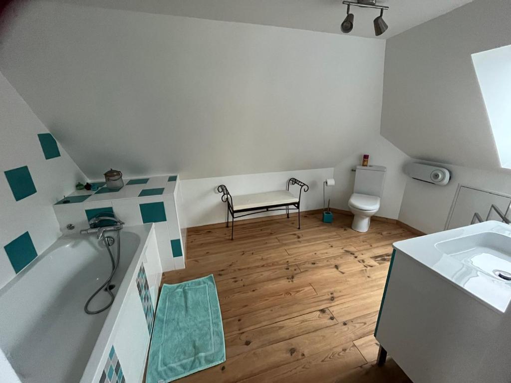 a bathroom with a tub and a sink and a toilet at La Fontaine - Détente - Piscine Jacuzzi - 12p in La Chartre-sur-le-Loir