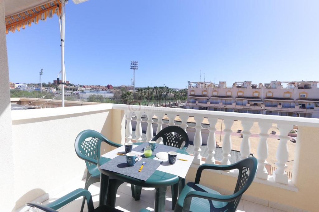 a table and chairs on a balcony with a view at 099 - Parque y playa 007 - comfortHOLIDAYS in Santa Pola