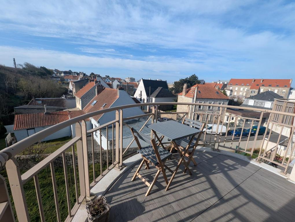 a balcony with a table and a view of a city at WimSaens in Wimereux