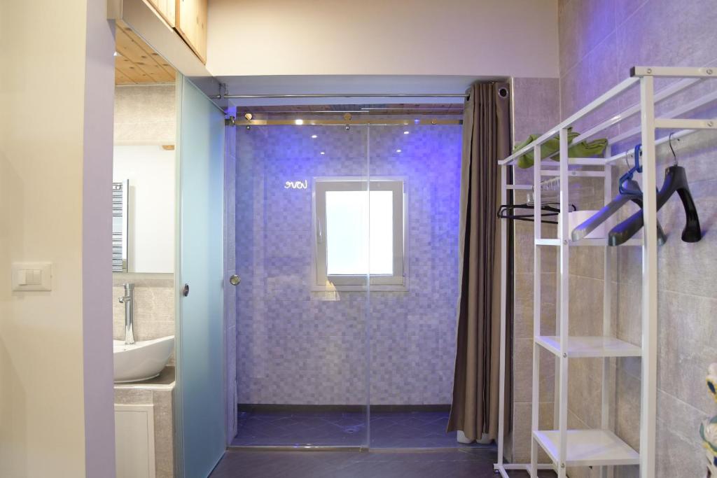 a bathroom with a walk in shower and a sink at Duomo Suite - A Step from the Cathedral in Monreale