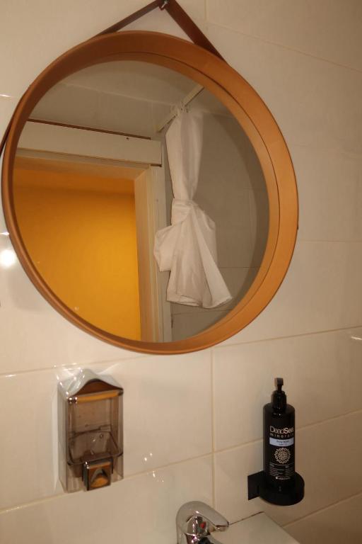 a mirror above a sink in a bathroom at Bella Vista House in Eilat