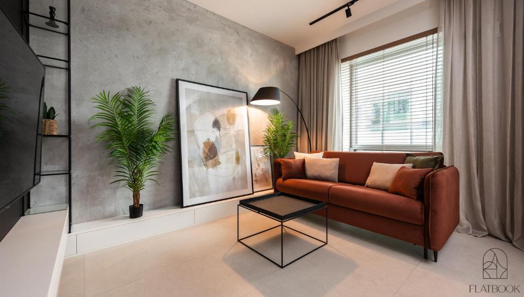 un salon avec un canapé et une table dans l'établissement Flatbook - Studio Yacht Park Gdynia, à Gdynia