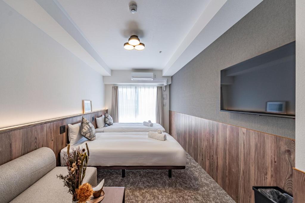 Ένα ή περισσότερα κρεβάτια σε δωμάτιο στο Apartment Hotel 11 Osaka Dome