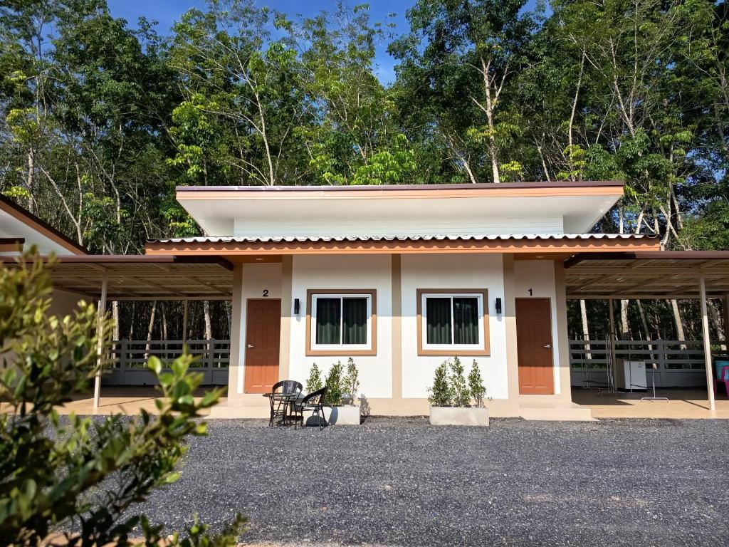 a small house with a porch at Good Nine Resort in Ban Lam Kaen
