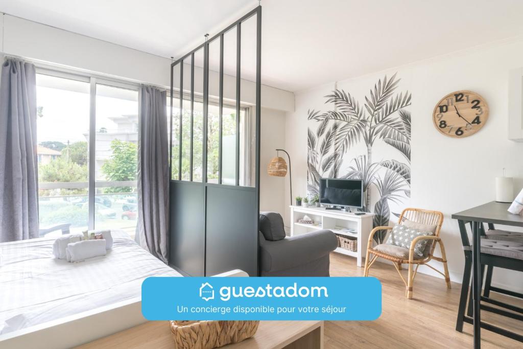 a living room with a large window and a desk at L'EVASION - 500m plage - Parking - Wifi in La Baule