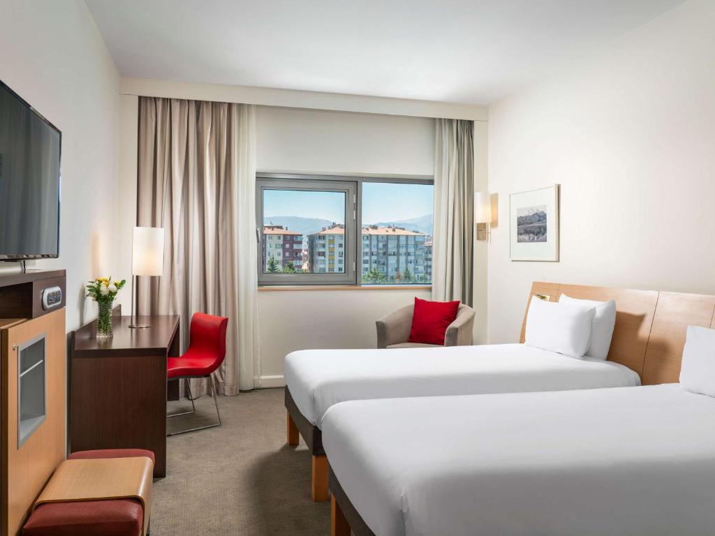 Cama ou camas em um quarto em Novotel Kayseri