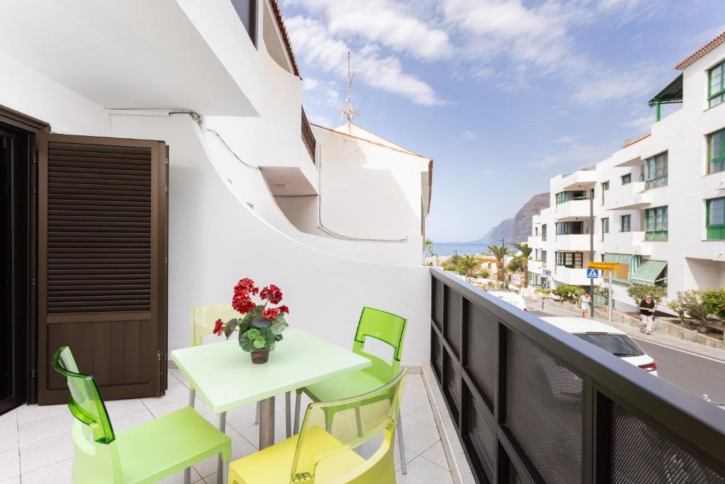 a balcony with a table and chairs and a view of a street at Santana Sunshine by Sunkeyrents in Santiago del Teide