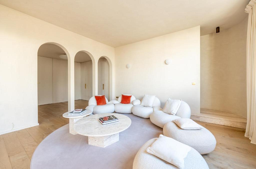un salon avec des canapés blancs et une table dans l'établissement Lease Mobility l Champs-Elysée & Eiffel View l Triplex 2BR & Rooftop, à Paris