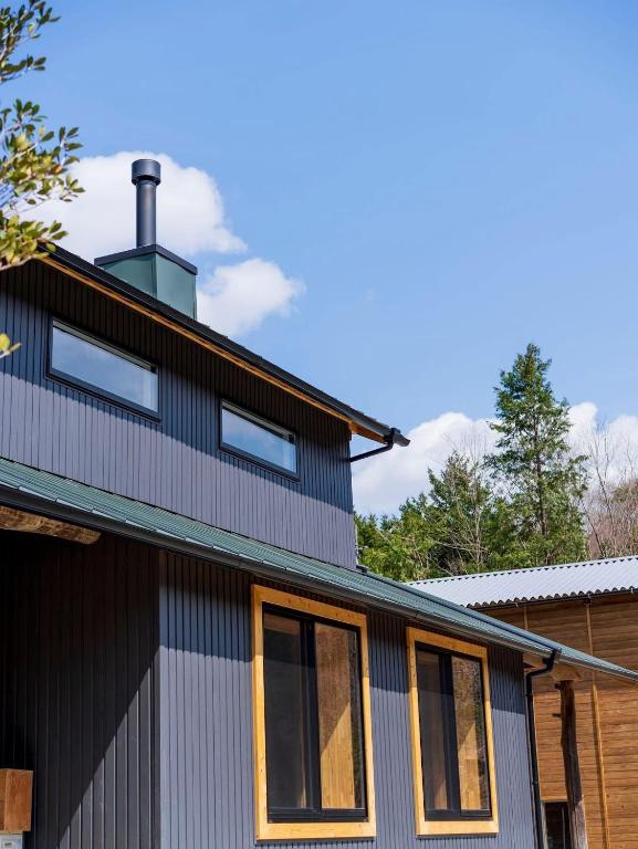 a house with a chimney on top of it at GOMYO LIFE Hotel in Higashikagawa