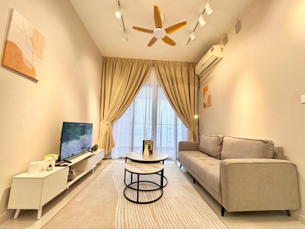 a living room with a couch and a tv at Kingsbay Danga Bay Country Garden by Luxecocoo CK in Johor Bahru