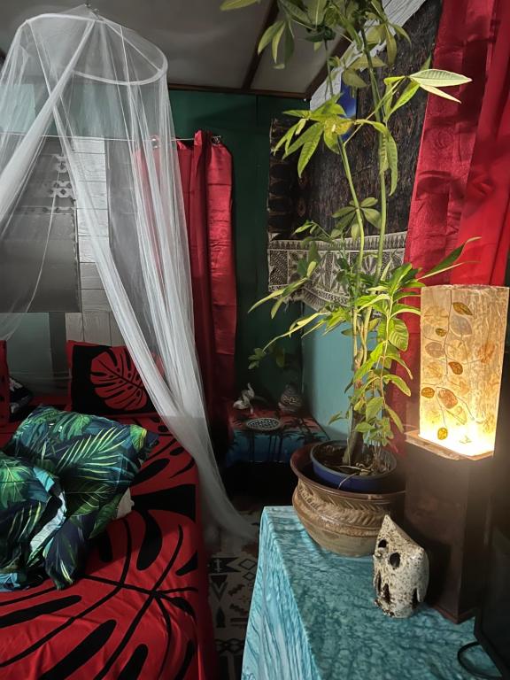 a room with two potted plants on a table at Fare Te ava Fitii in Fitii