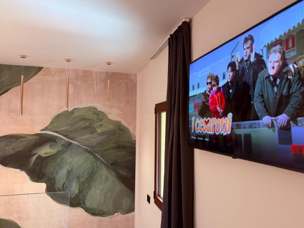 a flat screen tv on a wall in a room at Krysos Luxury Rooms in Agrigento