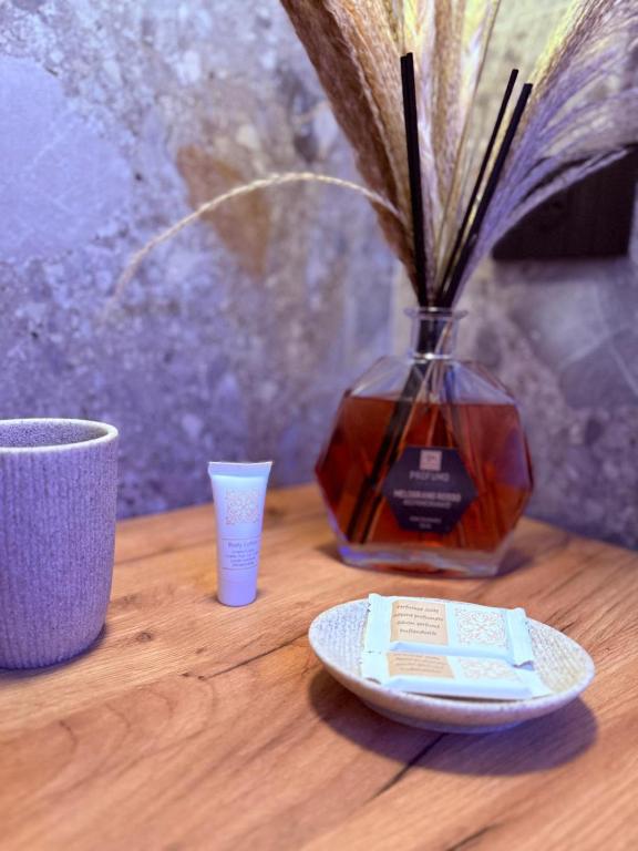 a table with a vase and a plate and a cup at Krysos Luxury Rooms in Agrigento