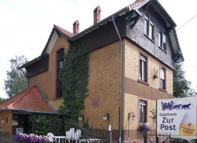 a building with a sign in front of it at Gästezimmer Polster in Birstein