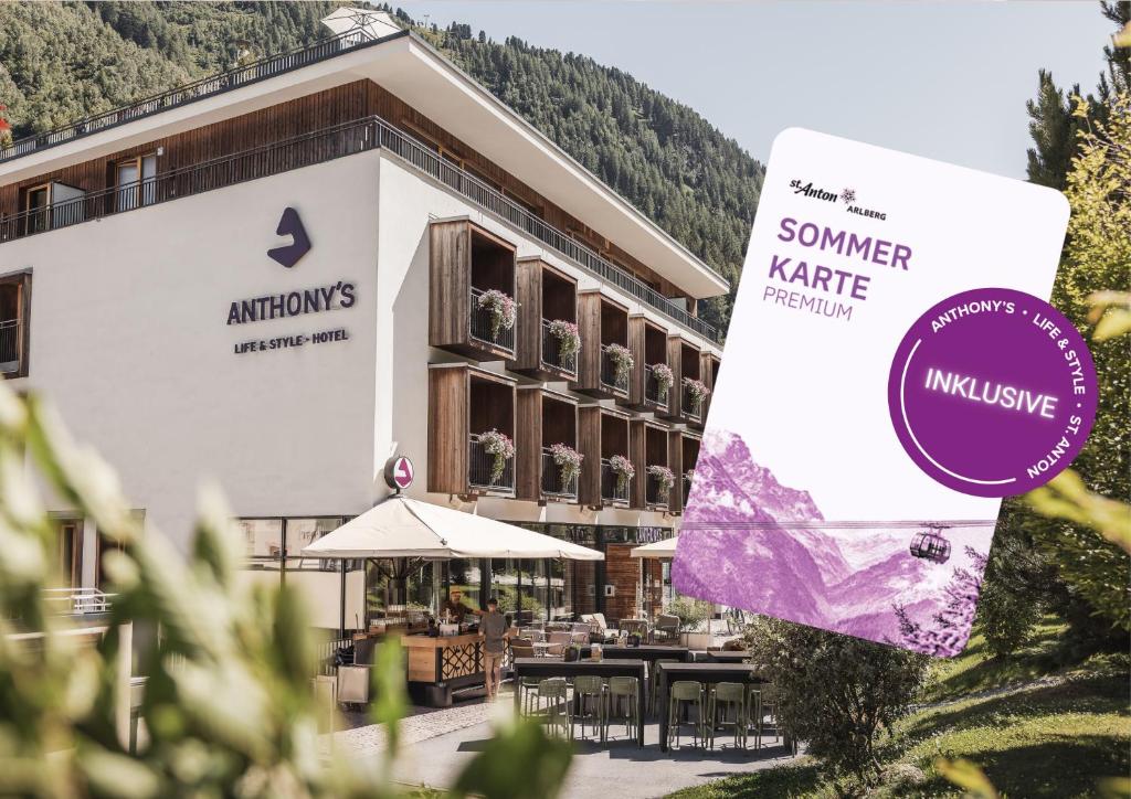 a hotel with a sign in front of a building at Anthony's Life&Style Hotel in Sankt Anton am Arlberg