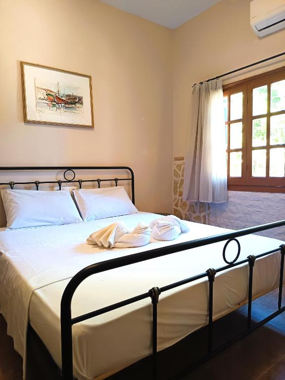 a bed with two towels on it in a bedroom at TheOldHouse Seaview in Corfu