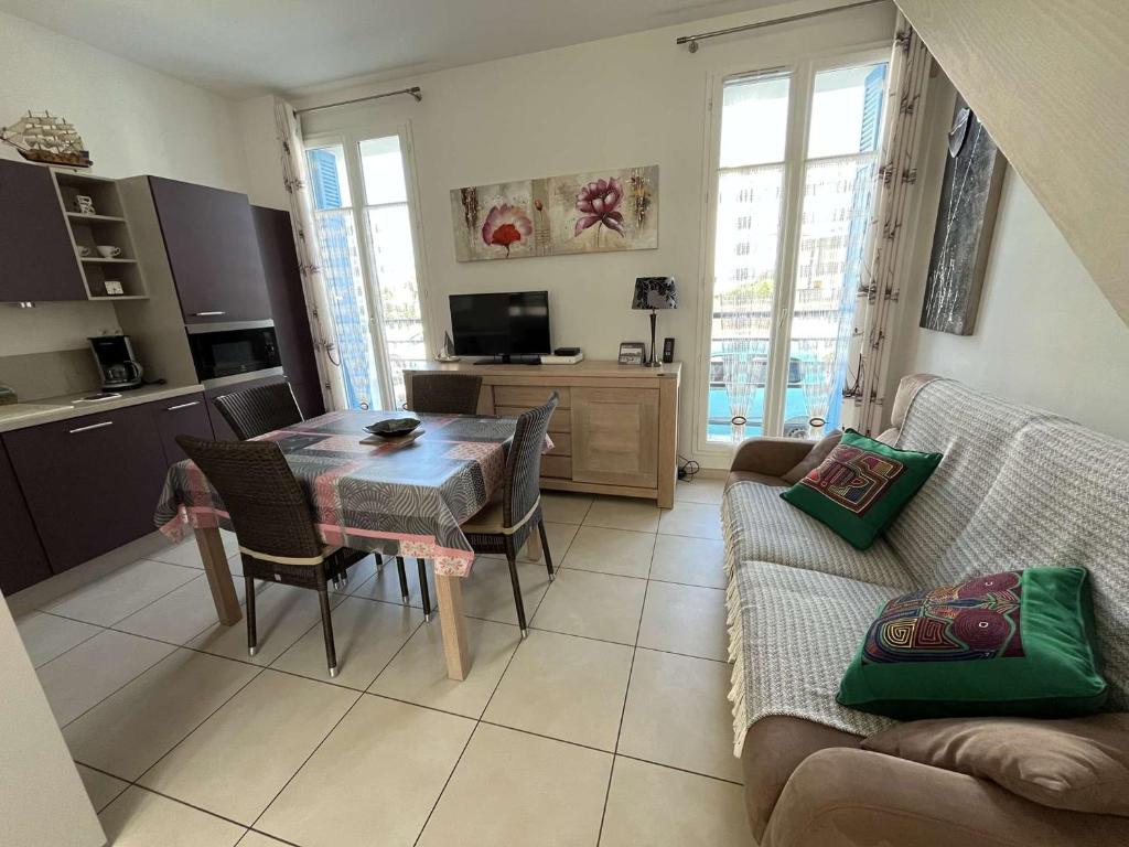 un salon avec une table et un canapé dans l'établissement Maison cosy proche plage Boisvinet, 2 chambres, cour, parking, Wi-Fi, à Saint-Gilles-Croix-de-Vie - FR-1-324-133, à Saint-Gilles-Croix-de-Vie