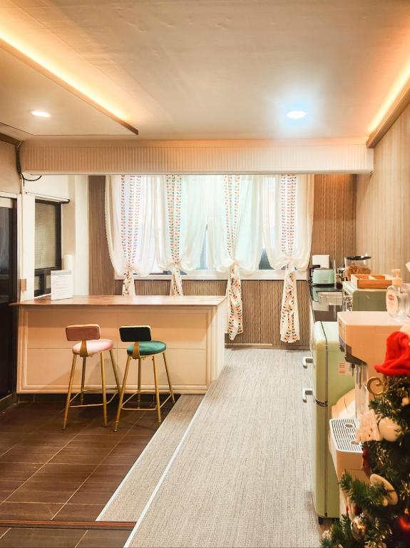 a waiting room with a christmas tree in front of windows at Romance Hotel in Seoul