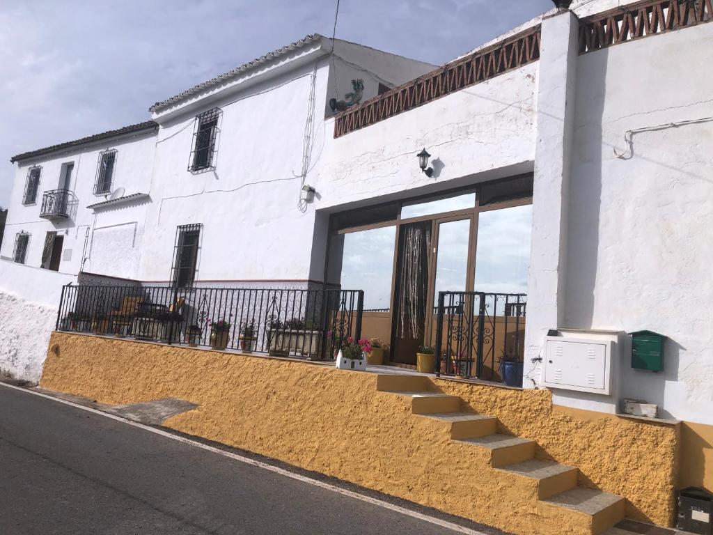 a white building with stairs in front of it at Large 1 bed apartment in the beautiful countryside in Rute
