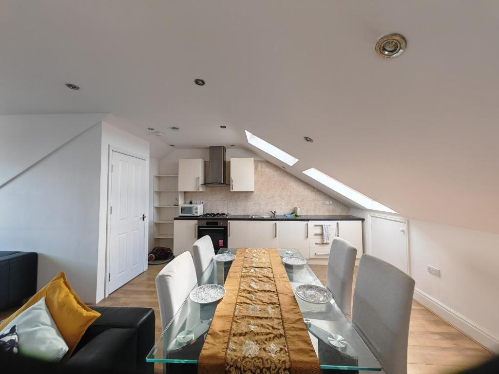 a dining room with a long table and chairs at Lovely double bed room in London