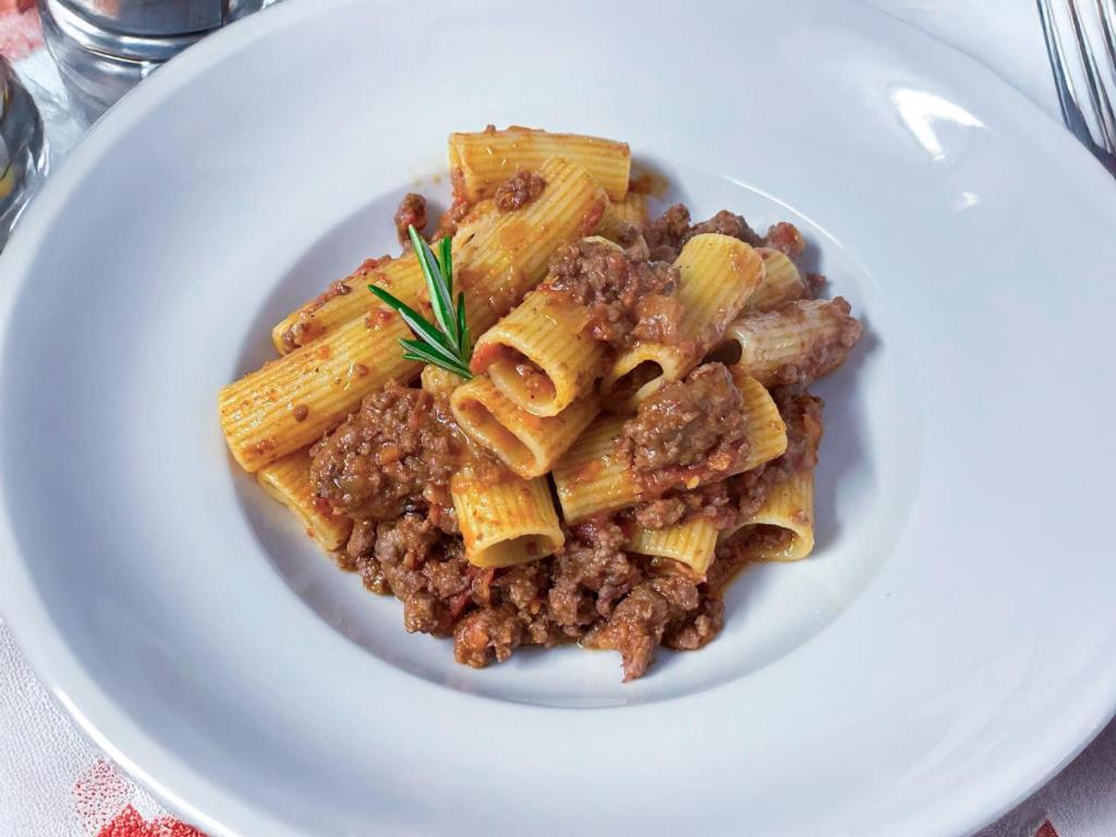 a plate of pasta with minced meat on a plate at Hotel Rialto in Barcelona