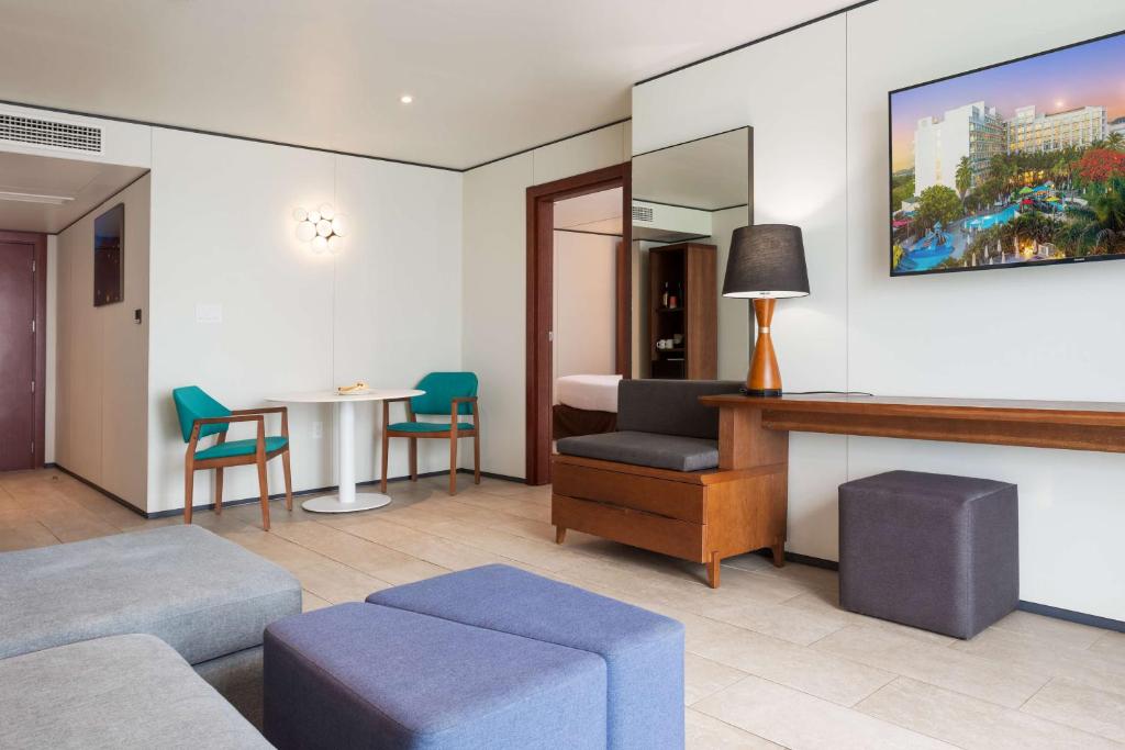 a living room with a couch and a table at Sonesta Maho Beach All Inclusive Resort Casino & Spa in Maho Reef