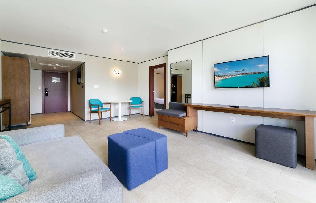 a living room with a couch and a table at Sonesta Maho Beach All Inclusive Resort Casino & Spa in Maho Reef