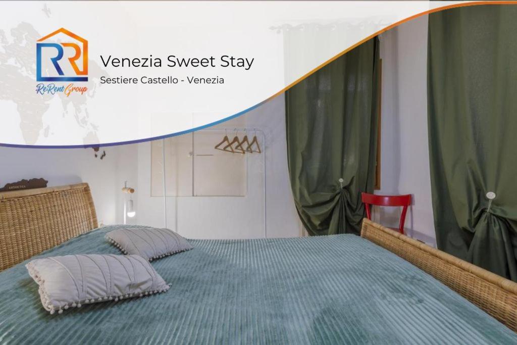a bedroom with a bed with a blue comforter at Art & Culture Biennale - Venezia Sweet Stay in Venice