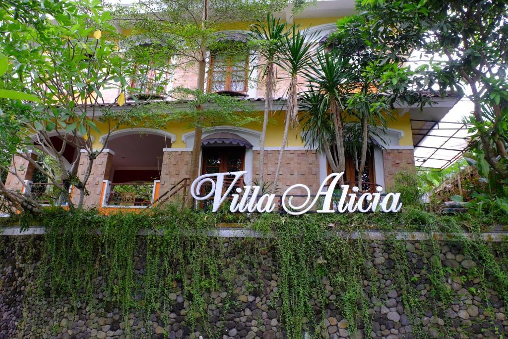 a house with trees in front of it at Villa Alicia - Pavillion Lily in Yogyakarta