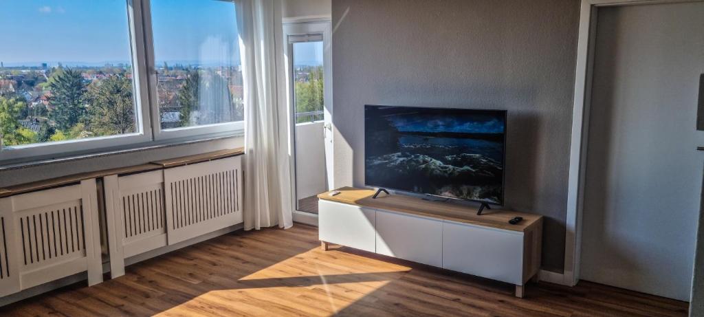 salon z kominkiem i dużym oknem w obiekcie Apartment Hannover - Langenhagen center 2 w Hanowerze