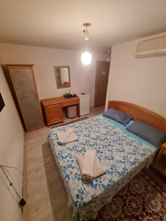 a bedroom with a bed and a desk in it at Özmert otel in Antalya