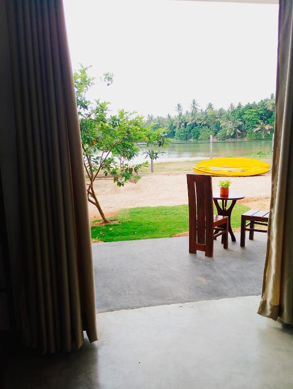 a view from a window of a patio with a table at Crush River Villa Hikkaduwa in Hikkaduwa