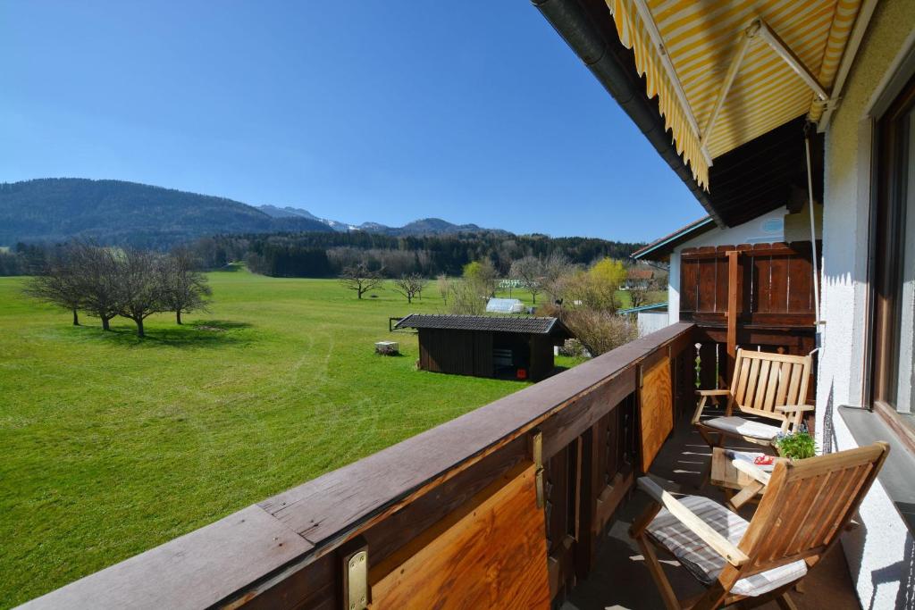 a balcony with chairs and a view of a yard at Bergblick in Bernau am Chiemsee