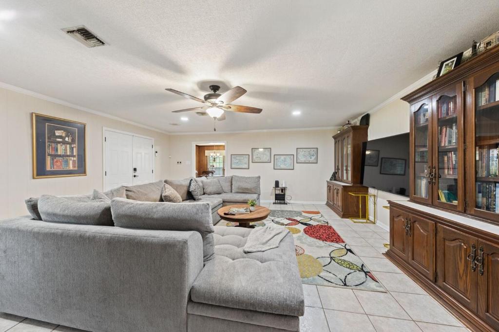a living room with a couch and a table at Cajun Stays Cozy 3BR Ranch Near Lafayette with WiFi and Parking in Broussard