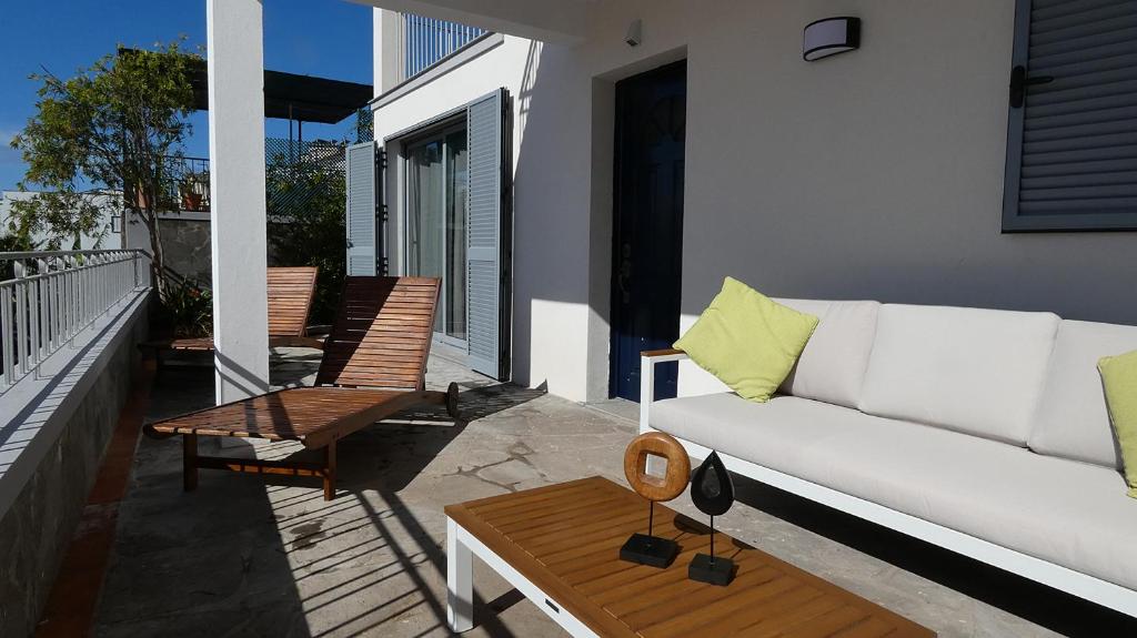 un divano bianco sul balcone di una casa di Madeira Serenity Cottage a Funchal