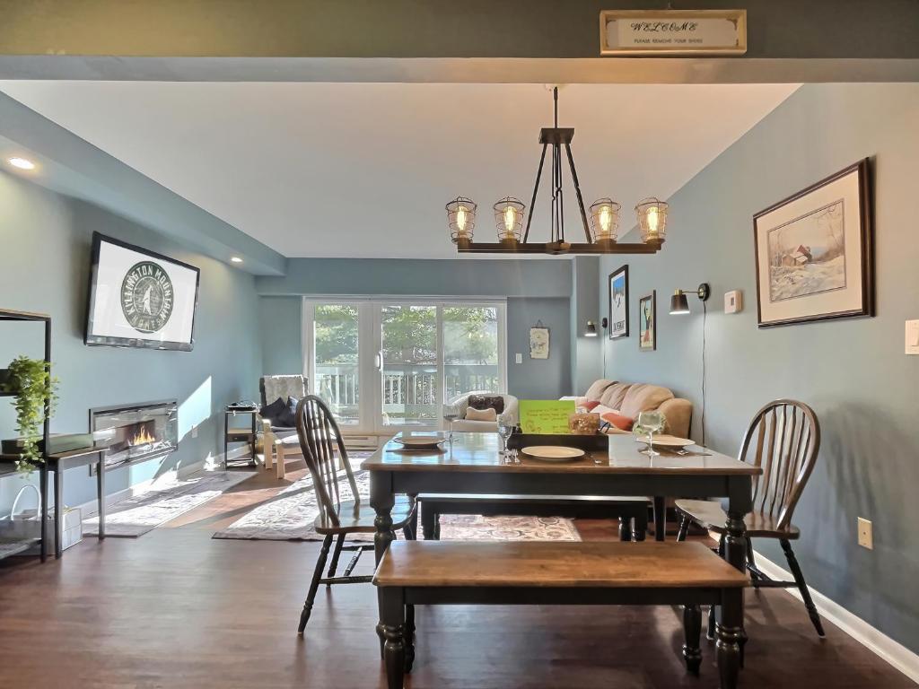 a dining room with a table and a couch at Moose Tracks Lodge - Pool, Hot Tub, Golf, Sauna in Killington