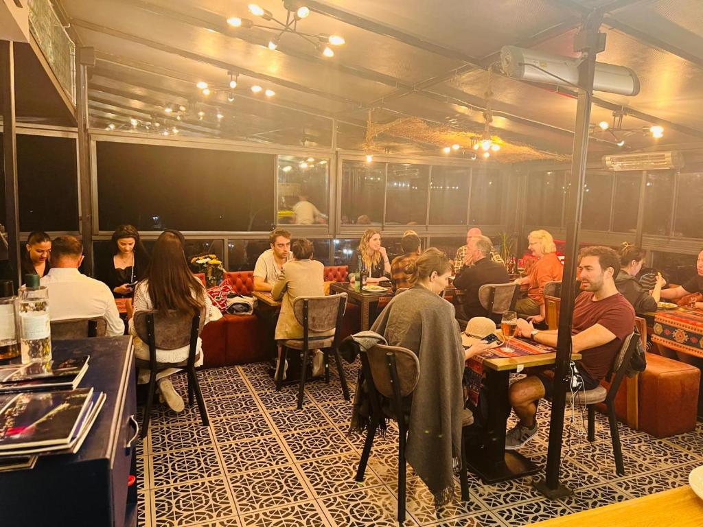 a group of people sitting at tables in a room at Ottoman Luxury Hotel in Istanbul