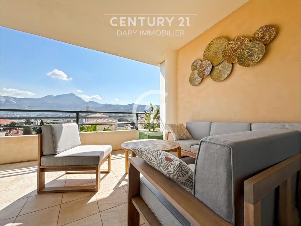 d'un salon avec un canapé et des chaises sur un balcon. dans l'établissement Victoria Calvi - Appartement T2, à Calvi