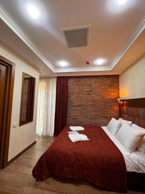 Postel nebo postele na pokoji v ubytování AMARCORD BOUTIQUE HOTEL