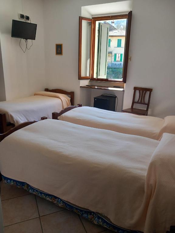 Łóżko lub łóżka w pokoju w obiekcie Acquacheta Valtancoli Hotel B&B