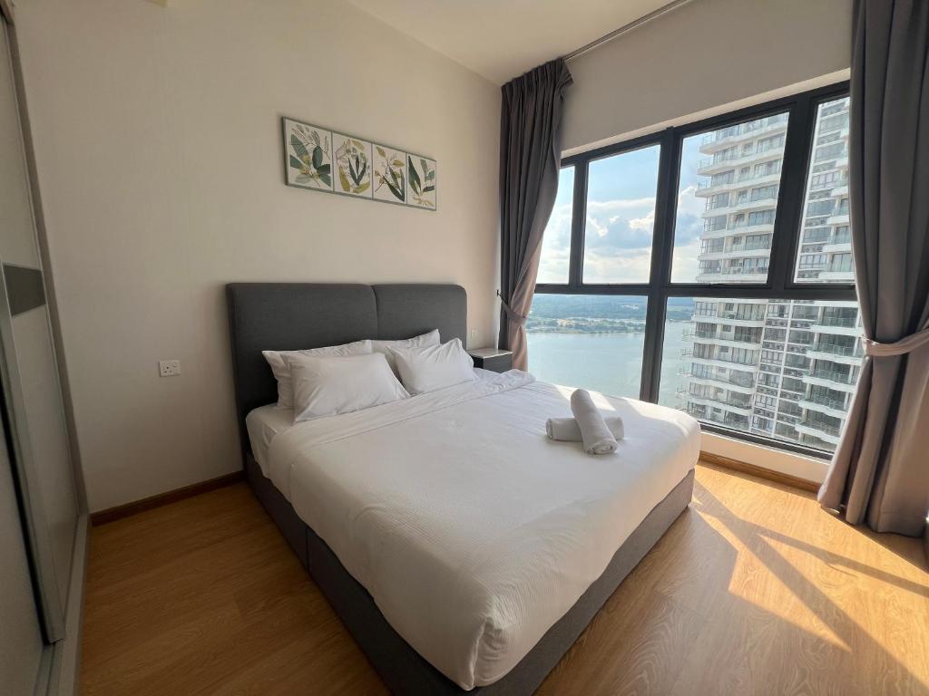 a bedroom with a large bed with a large window at DangaBay 2R 4pax with Balcony Seaview near CIQ by Wehome in Johor Bahru