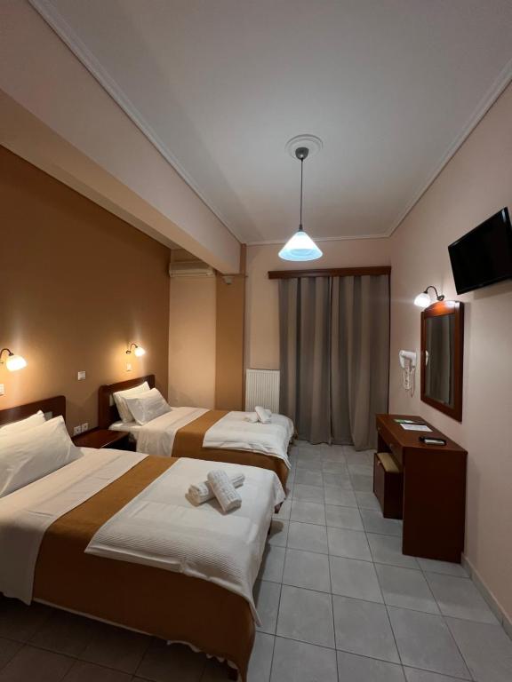 Postel nebo postele na pokoji v ubytování Hotel Nevada Kalamata