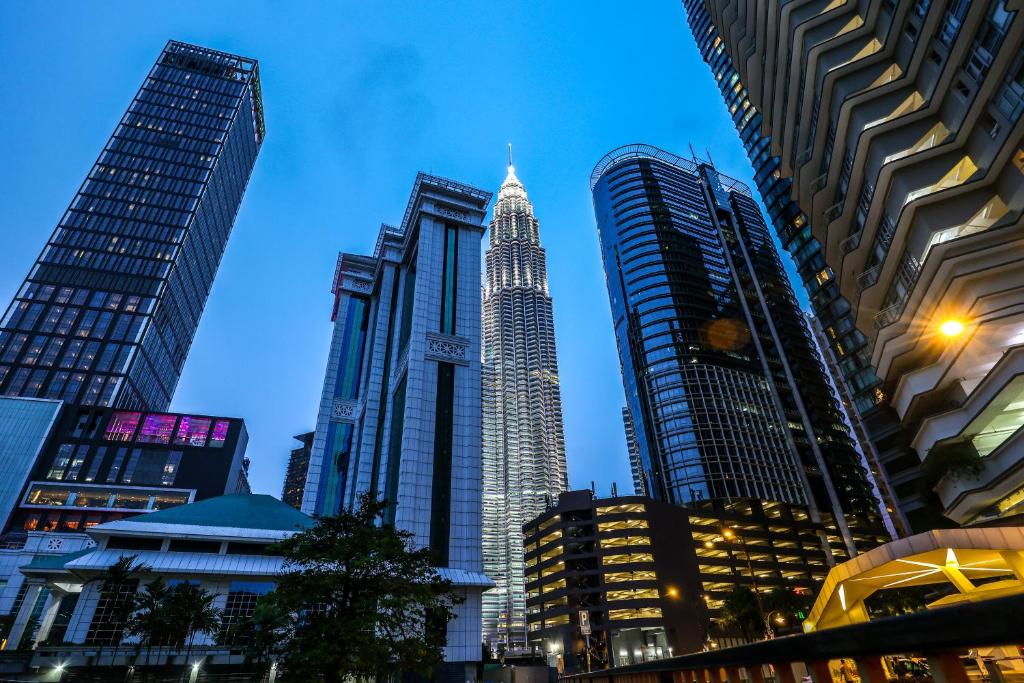 a group of tall buildings in a city at Sky Suites KLCC By Calm Sojourn in Kuala Lumpur