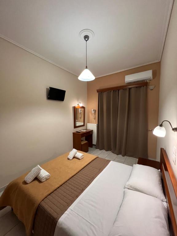 Postel nebo postele na pokoji v ubytování Hotel Nevada Kalamata