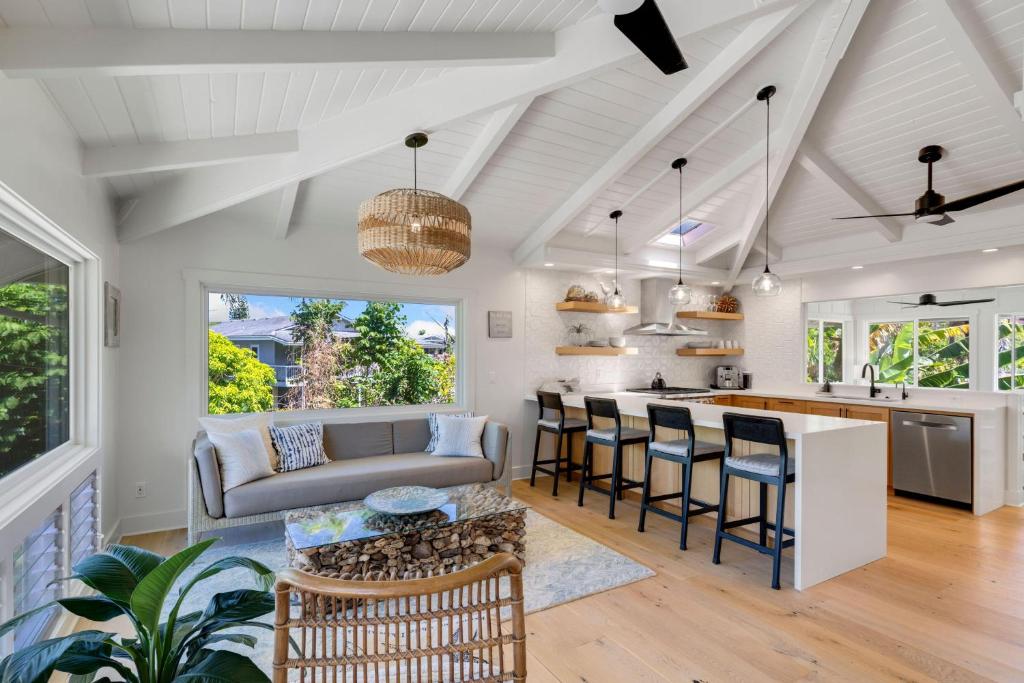 a kitchen and living room with a couch and a table at Camp Magic 2 in Hanalei