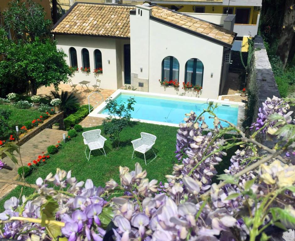 a villa with a swimming pool and a house at Villa Miami Taormina in Taormina