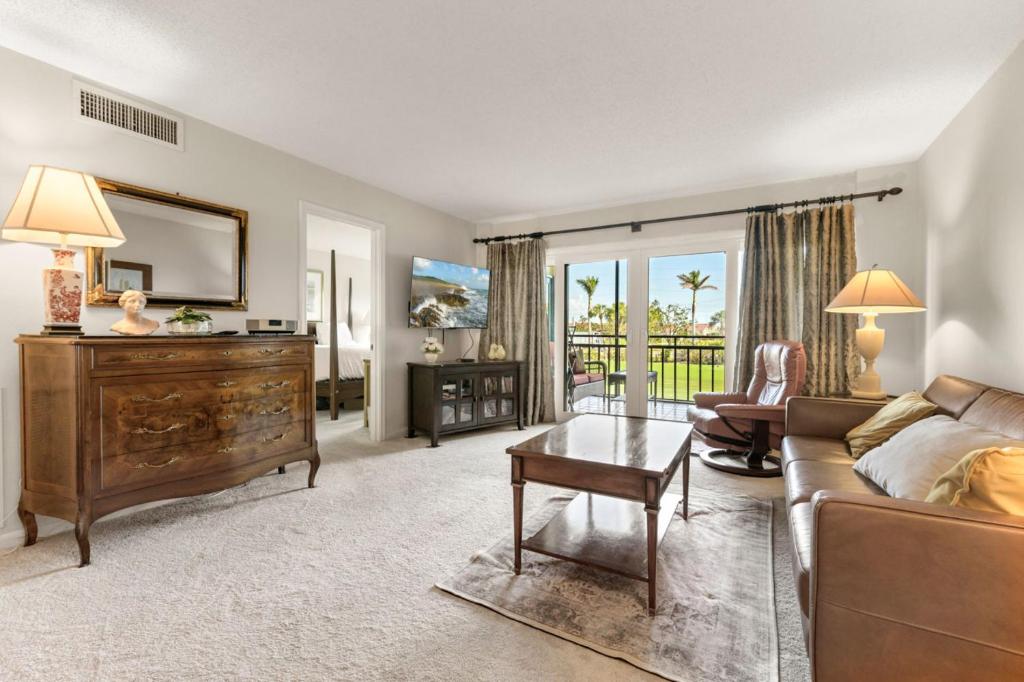 a living room with a couch and a table at Charming 2-Bedroom, 2-Bath Condo with Golf Course Views in Isla Del Sol in Point Brittany