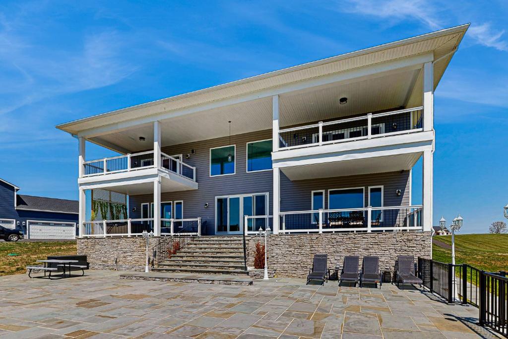 a large house with a porch and a patio at Sunset Valley in Kirk O'Cliff